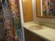 Bathroom with shower, sink, and floral shower curtain at 1208 44Th Avenue E Dr, Ellenton, FL 34222