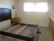 Spacious bedroom with a large dresser and a bed frame at 1208 44Th Avenue E Dr, Ellenton, FL 34222