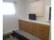Bedroom with built-in dresser and a wall-mounted TV at 1208 44Th Avenue E Dr, Ellenton, FL 34222