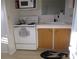 Small kitchen with white appliances and wood cabinets at 1208 44Th Avenue E Dr, Ellenton, FL 34222