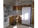 Efficient kitchen featuring white appliances and wood cabinets at 1208 44Th Avenue E Dr, Ellenton, FL 34222