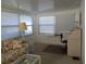 Bright sunroom features window blinds, comfy seating, and a workspace at 1208 44Th Avenue E Dr, Ellenton, FL 34222