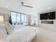 Spacious bedroom with water views, fireplace, and light hardwood floors at 1233 N Gulfstream Ave # 301, Sarasota, FL 34236