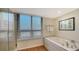 Relaxing bathroom with soaking tub and large window at 1255 N Gulfstream Ave # 1101, Sarasota, FL 34236