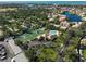Aerial view of community amenities including tennis courts and a pool, enhancing lifestyle and recreation at 148 Inlets Blvd # 148, Nokomis, FL 34275