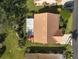 Aerial view of the house and its surrounding landscape showcases a well-maintained roof and lush grounds at 148 Inlets Blvd # 148, Nokomis, FL 34275