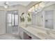 Bright bathroom features dual sinks, ample counter space, and a glass-enclosed shower at 148 Inlets Blvd # 148, Nokomis, FL 34275