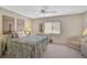 Bright bedroom features a ceiling fan, window, and light neutral walls, enhancing a peaceful atmosphere at 148 Inlets Blvd # 148, Nokomis, FL 34275