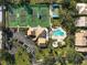 Community tennis courts and pool, surrounded by lush greenery at 148 Inlets Blvd # 148, Nokomis, FL 34275
