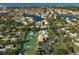 Wide aerial view of community including tennis courts and pool at 148 Inlets Blvd # 148, Nokomis, FL 34275