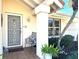 Inviting front entry with secure storm door, tiled porch, and charming decorative details at 148 Inlets Blvd # 148, Nokomis, FL 34275