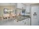 Kitchen featuring granite counters, white cabinets, and a view of the adjacent dining area at 148 Inlets Blvd # 148, Nokomis, FL 34275