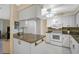 Functional kitchen with granite countertops, white cabinetry, and modern appliances at 148 Inlets Blvd # 148, Nokomis, FL 34275