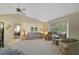 Spacious living room featuring neutral carpet, comfortable seating, and a bay window for natural light at 148 Inlets Blvd # 148, Nokomis, FL 34275