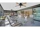 Spacious sunroom with comfortable furniture, tiled flooring, and access to the dining area at 148 Inlets Blvd # 148, Nokomis, FL 34275