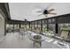 Relaxing sunroom with ceiling fans, shade screens, and views of lush landscaping at 148 Inlets Blvd # 148, Nokomis, FL 34275