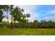 Riverfront view with lush landscaping at 14924 Sora Way, Bradenton, FL 34212