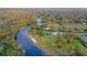 Aerial view of waterfront property with lush landscaping at 14924 Sora Way, Bradenton, FL 34212