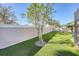 Landscaped backyard with artificial turf and privacy wall at 14924 Sora Way, Bradenton, FL 34212