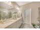 Elegant bathroom with double vanity, large mirror, and walk-in shower at 14924 Sora Way, Bradenton, FL 34212