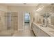 Bathroom with double vanity, walk in shower, and view into bedroom at 14924 Sora Way, Bradenton, FL 34212
