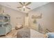 Cozy bedroom with queen bed, decorative shelving, and window with shutters at 14924 Sora Way, Bradenton, FL 34212