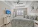 Spacious bedroom with large bed, dresser, and window with plantation shutters at 14924 Sora Way, Bradenton, FL 34212