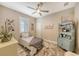 Charming bedroom with a twin bed, decorative shelving, and window with shutters at 14924 Sora Way, Bradenton, FL 34212