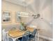 Charming dining room features a rustic wooden table and blue accent chairs at 14924 Sora Way, Bradenton, FL 34212