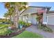 Landscaped front yard with palm trees and brick walkway leading to the house entrance at 14924 Sora Way, Bradenton, FL 34212