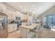 Spacious kitchen with island seating, stainless steel appliances, and white cabinets at 14924 Sora Way, Bradenton, FL 34212