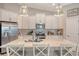 Bright kitchen with white cabinets, stainless steel appliances, and quartz countertops at 14924 Sora Way, Bradenton, FL 34212