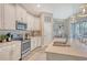 Well-designed kitchen with white cabinets, stainless steel appliances, and a large island at 14924 Sora Way, Bradenton, FL 34212