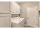 Bright laundry room with washer, dryer, and ample cabinet space at 14924 Sora Way, Bradenton, FL 34212