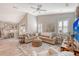 Spacious living room with sectional sofa, ottoman, and large TV at 14924 Sora Way, Bradenton, FL 34212