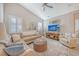Spacious living room with sectional sofa, ottoman, and large TV at 14924 Sora Way, Bradenton, FL 34212