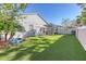 Spacious backyard with turf grass, covered patio, and fire pit at 14924 Sora Way, Bradenton, FL 34212