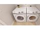 Laundry room with side-by-side Samsung washer and dryer at 15213 Shady Palms Ln, Nokomis, FL 34275