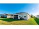 Home's backyard, featuring a screened patio and lush lawn at 15813 6Th E Ave, Bradenton, FL 34212