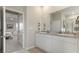 Double vanity bathroom with granite countertop and view into bedroom at 15813 6Th E Ave, Bradenton, FL 34212