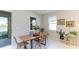 Bright dining area with wooden table and wicker chairs, overlooking the lake at 15813 6Th E Ave, Bradenton, FL 34212