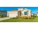 Tan house with a black door, stone accents, and a neatly landscaped front yard at 15813 6Th E Ave, Bradenton, FL 34212