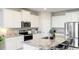 Modern kitchen with white cabinets, granite island and stainless steel appliances at 15813 6Th E Ave, Bradenton, FL 34212