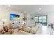 Living room features a large sectional sofa and sliding glass doors to patio at 15813 6Th E Ave, Bradenton, FL 34212