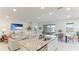 Open living room with a view of the lake, features a large TV and comfortable seating at 15813 6Th E Ave, Bradenton, FL 34212