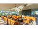Covered lounge area with orange couches and fire pit at 15813 6Th E Ave, Bradenton, FL 34212