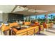 Outdoor lounge area with orange couches and a bar at 15813 6Th E Ave, Bradenton, FL 34212