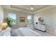 Main bedroom with a ceiling fan, large windows and a view of the lake at 15813 6Th E Ave, Bradenton, FL 34212