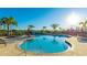 Community pool with surrounding lounge chairs and palm trees at 15813 6Th E Ave, Bradenton, FL 34212