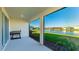 Covered patio with lake view, includes a grill and seating at 15813 6Th E Ave, Bradenton, FL 34212